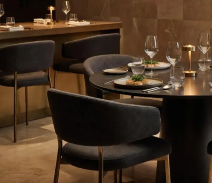 Premium Australian restaurant interior with travertine, walnut timber, brass details and lush greenery